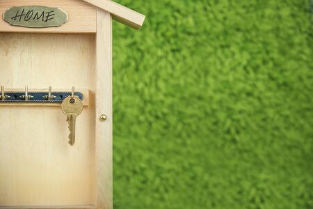 Property insurance and security concept.Wooden Key Holder House with  isolated white backgroundの写真素材