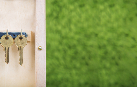 Property insurance and security concept.Wooden Key Holder House with  isolated white backgroundの写真素材