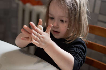 preschool child playing with molding shapes