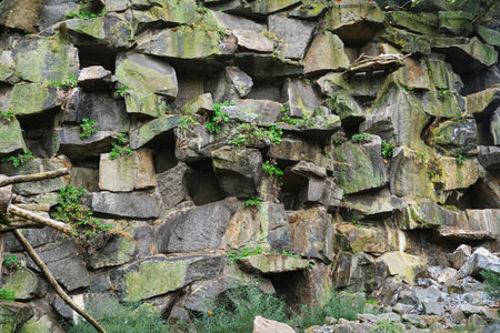 natural stone rock wall mountain with green grass
