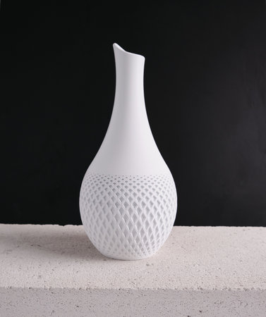 creative 3D technology printed white vase home decor with a flowing geometric texture Decorative Vase For Flowers made from recycled plastic isolated black backgroundの写真素材