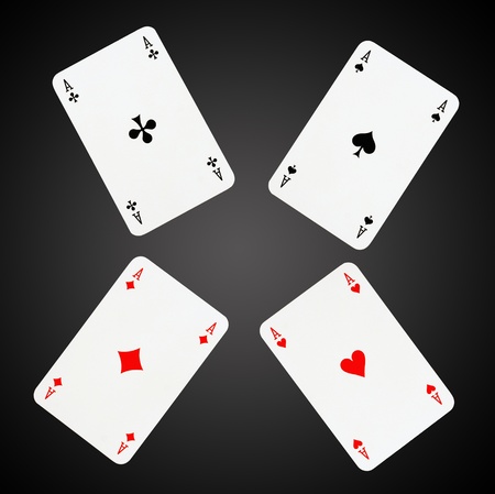 Aces playing cards isolated on black-gray background