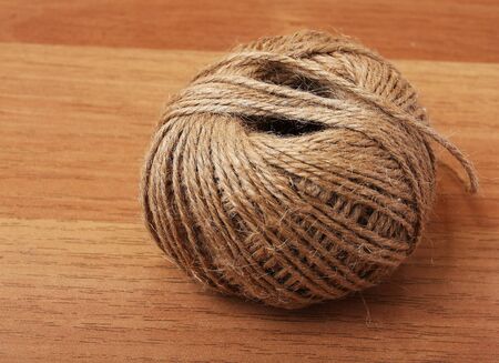 Rope clew detail on a wooden table の写真素材