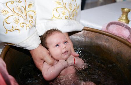 Newborn baby water baptism ritualの写真素材