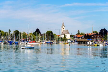 View on lake Chiemsee by Seebruck port, marina with boats, sailboats. Bavaria, Bayern, Germanyの写真素材