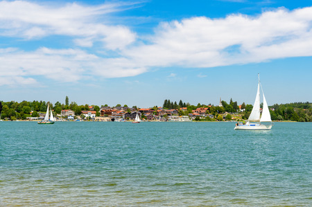 View on lake Chiemsee with a boat, Sailboat on Gstadt from Fraueninsel, Frauenchiemsee.  Bavaria, Bayern, Germanyのeditorial素材
