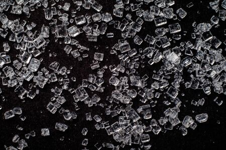 Close up view of sugar. Black background