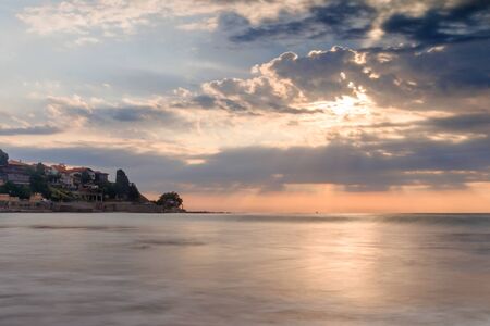 Great sunshine in nesebar Bulgaria. Cloud sky. Big wave. Long exposition.の写真素材
