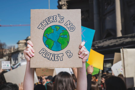 Striking school aged children in central London over climate change holding a placard