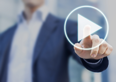 Businessman pressing play button to start or initiate projectsの写真素材