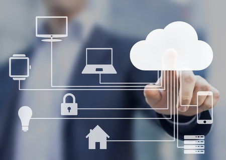 Businessman touching a cloud connected to many objects on a virtual screen, concept about internet...