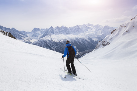 Skier skiing on red slope in Alps mountains near Chamonix, Franceの写真素材