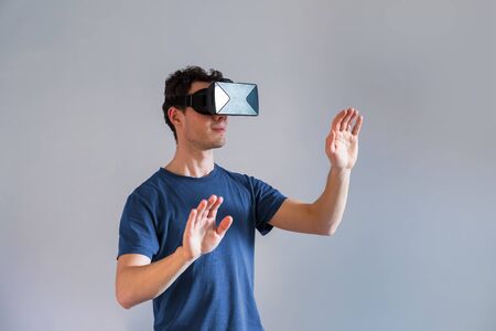 Person wearing a virtual reality (VR) headset or head-mounted display (HMD) glassesの写真素材