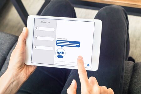 Chatbot with artificial intelligence technology (AI) internet virtual assistant on digital tablet...