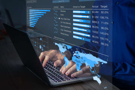 Manager analyzing business analytics dashboard with operations and sales metrics on computer. Late...