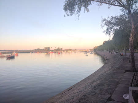 On the banks of a river with some boats.の写真素材