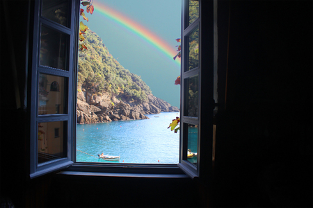 a window on the sea with a rainbowの写真素材