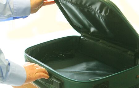 two hands open an empty suitcaseの写真素材