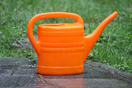 a watering can under the rainの写真素材