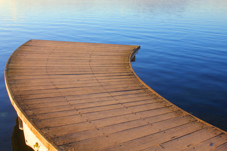 an interrupted wood bridge on the lakeの写真素材