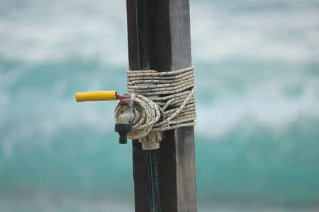 a tap on wooden poleの写真素材