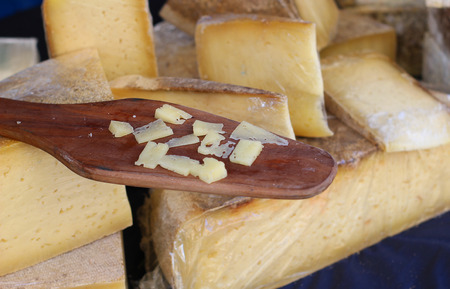 a wooden spoon with cheeseの写真素材
