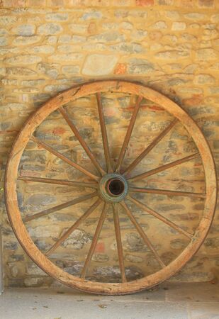 a big wood wheel on the wallの写真素材