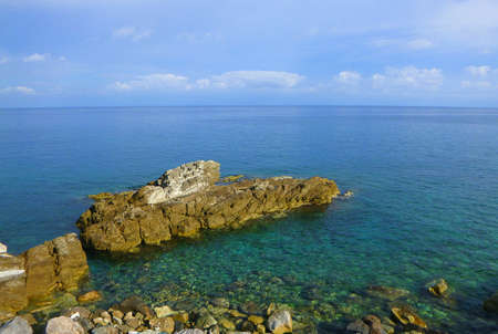 a seascape with rocks and stones in summerの写真素材