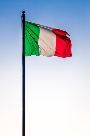 Flag of the Italian Republic waving in the wind against clear blue skyの写真素材