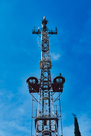 Old city television tower against the sky and trees. Old TV Tower.の写真素材