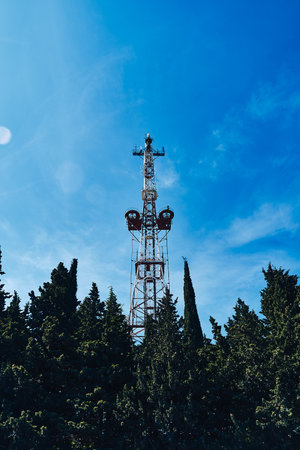 Old city television tower against the sky and trees. Old TV Tower.の写真素材