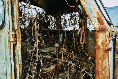 Old abandoned rusty broken tractor. Tractor in a landfill.の写真素材