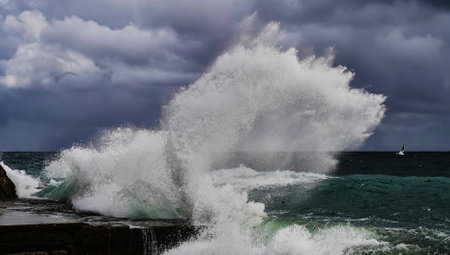 Stormy weather at sea. Strong waves hitting stones. Strong explosions from the waves of the sea.の写真素材