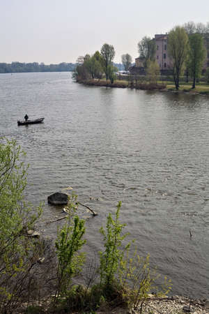Boat with a fisherman on a lake on a sunny day