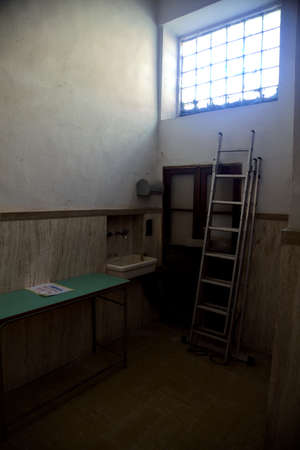 Utility room with a table and a ladder under a window