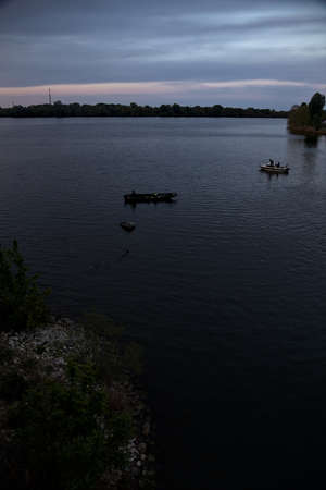 Fishing boats on a lake at dusk