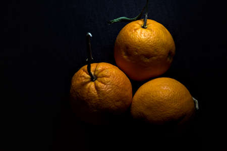 Three oranges on a black backgroundの写真素材