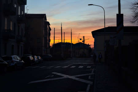 Railroad crossing in the shade at sunset in winterの写真素材