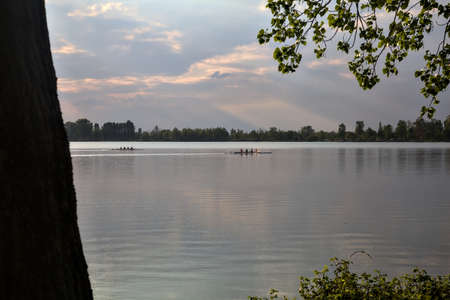 Canoe on a lake seen from the distance at sunset