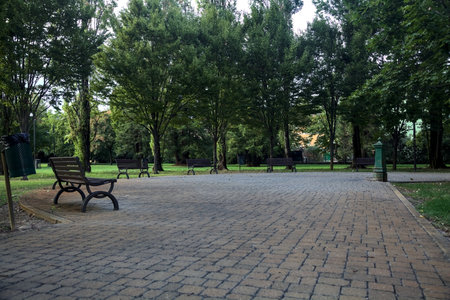Small square in a park with benches and a fountainの写真素材