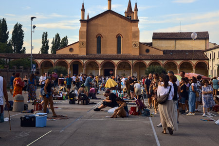 Street painters at a convention while drawing sacred pictures on the asphalt at sunsetのeditorial素材