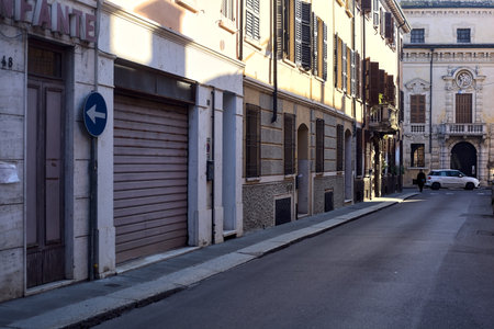 Narrow street in the shade in an italian townの写真素材