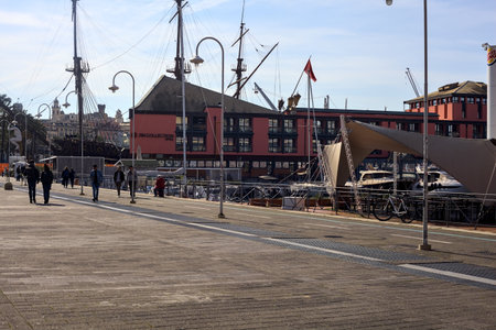 Boulevard in a pier with docked boats on a sunny dayのeditorial素材