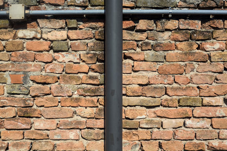 Brick wall with tubes on it