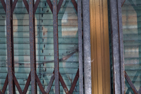 Shop window and a shutter in front of it seen up close