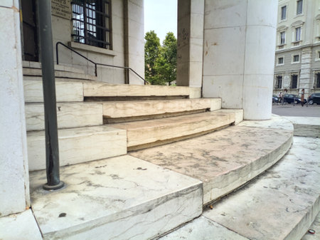 Entrance of a building with columns and a staircase in a square of an Italian townの写真素材