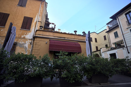 Front of a closed restaurant in a street of an italian town at sunsetの写真素材