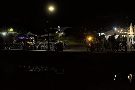 River in an Italian town during a fair at nightの写真素材