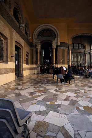 Mantua, Italy - September 2023 - Woman playing piano in the porch of a palace while audience is watchingのeditorial素材