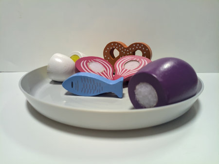Wooden toy food set on a plastic plate seen up close